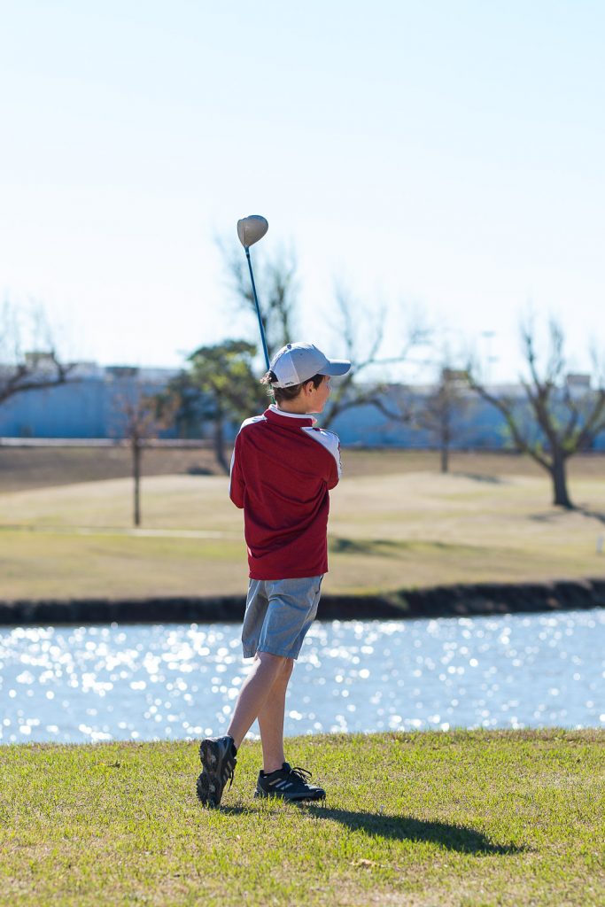 Young man golfing.